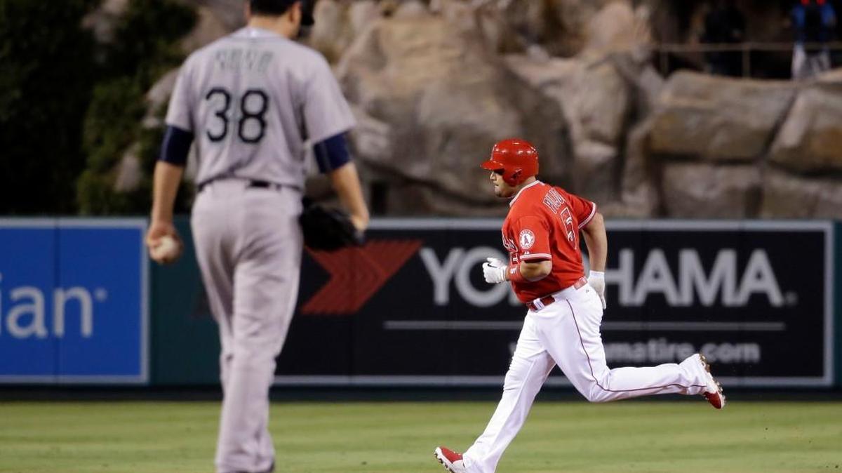 
Seattle Mariners starting pitcher Vidal Nuno, left, looks down as Los Angeles Angels' Albert Pujols rounds the bases after a two run, home run during the first inning of a baseball game in Anaheim, Calif., Friday, Sept. 25, 2015.
