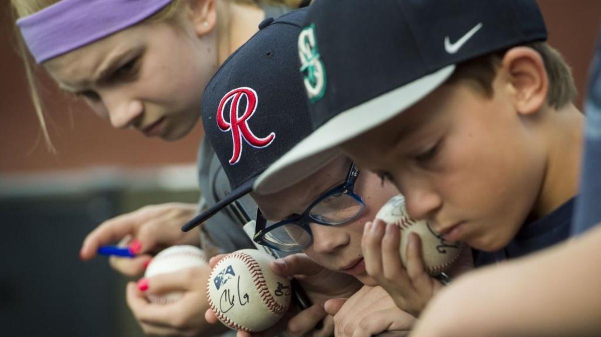 Madison Helms, far, Tommy Dickerson, center, and Hayden Kellington wait for autographs before the Minor League Baseball Home Run Derby at Cheney Stadium in Tacoma, Wash., on Monday, July 10, 2017.