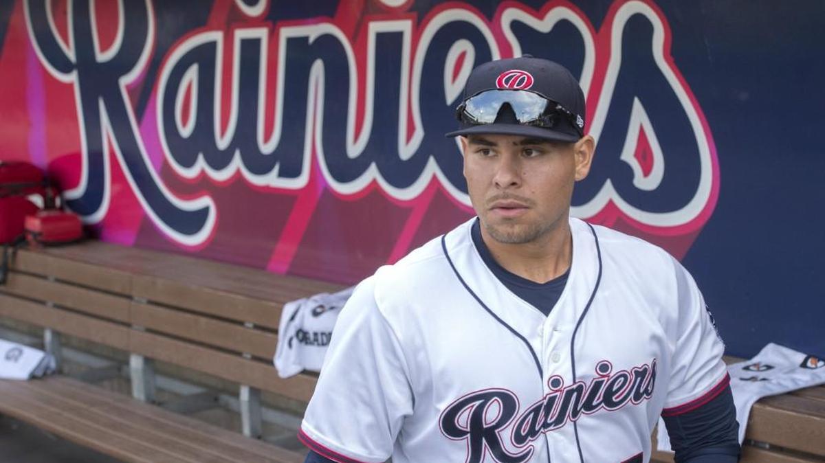 Tacoma Rainiers slugger Stefen Romero looks out from the dugout at Cheney Stadium on Thursday. Romero came up as a second baseman, but is getting time at other positions as he tries to make the major leagues.
