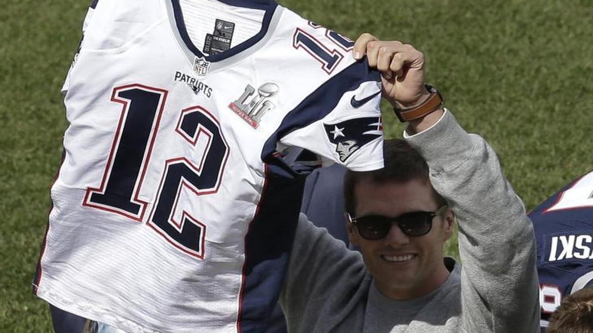 New England Patriots quarterback Tom Brady displays his recovered jersey, which was stolen from the locker room after the Patriots’ February Super Bowl victory over the Atlanta Falcons in Houston, during pregame ceremonies before the Boston Red Sox and the Pittsburgh Pirates opening day baseball game at Fenway Park on Monday in Boston. Dylan Wagner, 19, of Kent led the FBI to the stolen jersey.