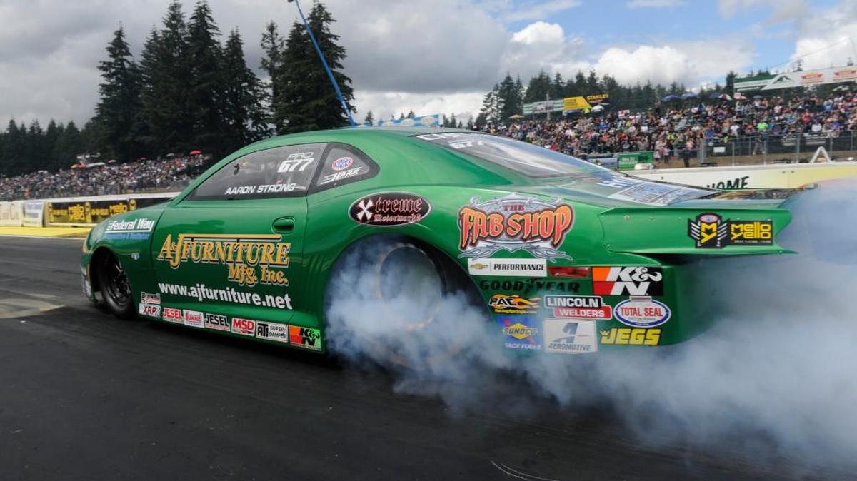 Aaron Strong powers his A&J Furniture Chevy Camaro in the Pro Stock semifinal round at the Protect the Harvest NHRA Northwest Nationals in Kent on Sunday. Strong won the race. Due to persistent rain, the Pro Stock final was postponed until the Lucas Oil NHRA Nationals in Brainerd, Minn., Aug. 18-21. Strong will face Vincent Nobile in the championship round.