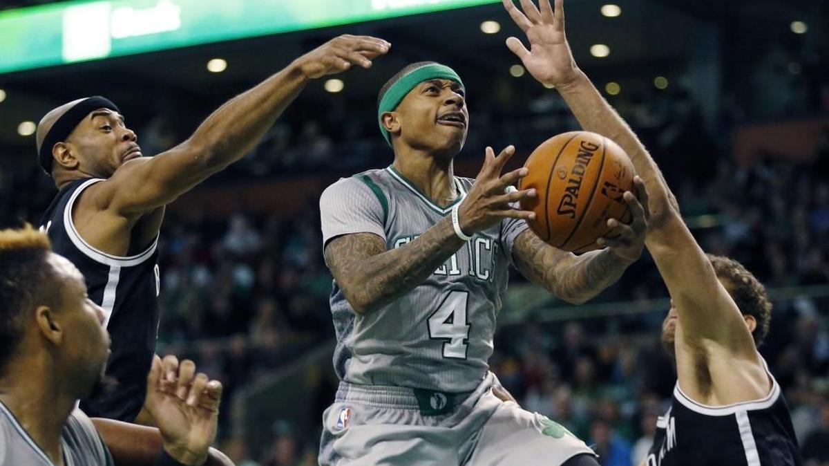Boston Celtics' Isaiah Thomas (4) goes up to shoot between Brooklyn Nets' Jarrett Jack, left, and Brook Lopez, right, during the second quarter of an NBA basketball game in Boston, Saturday, Jan. 2, 2016.