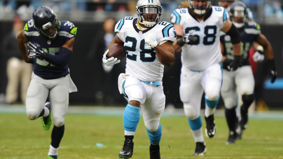 Carolina’s Jonathan Stewart (28) picks up yardage in a Jan. 17 playoff game against Seattle. The former Timberline standout has rushed for 189 yards in the Panthers’ two playoff games.