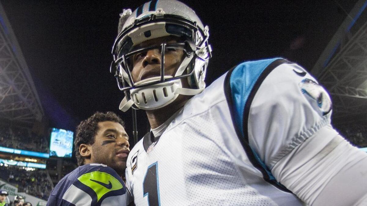 Seahawks quarterback Russell Wilson and Panthers quarterback Cam Newton meet after their game in Seattle in December 2016. They will meet for the ninth time in their careers in September, now that Newton has agreed to sign with the New England Patriots.