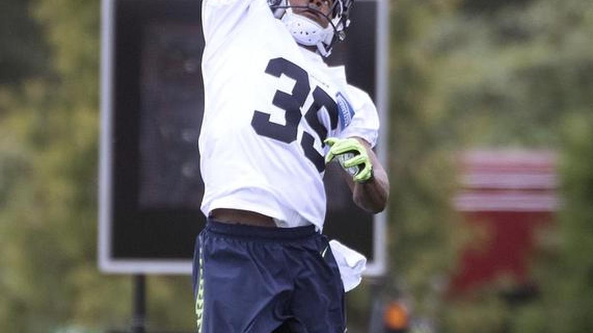 Seattle Seahawks cornerback DeShawn Shead leaps for the ball during drills on the opening day of training camp July 30.