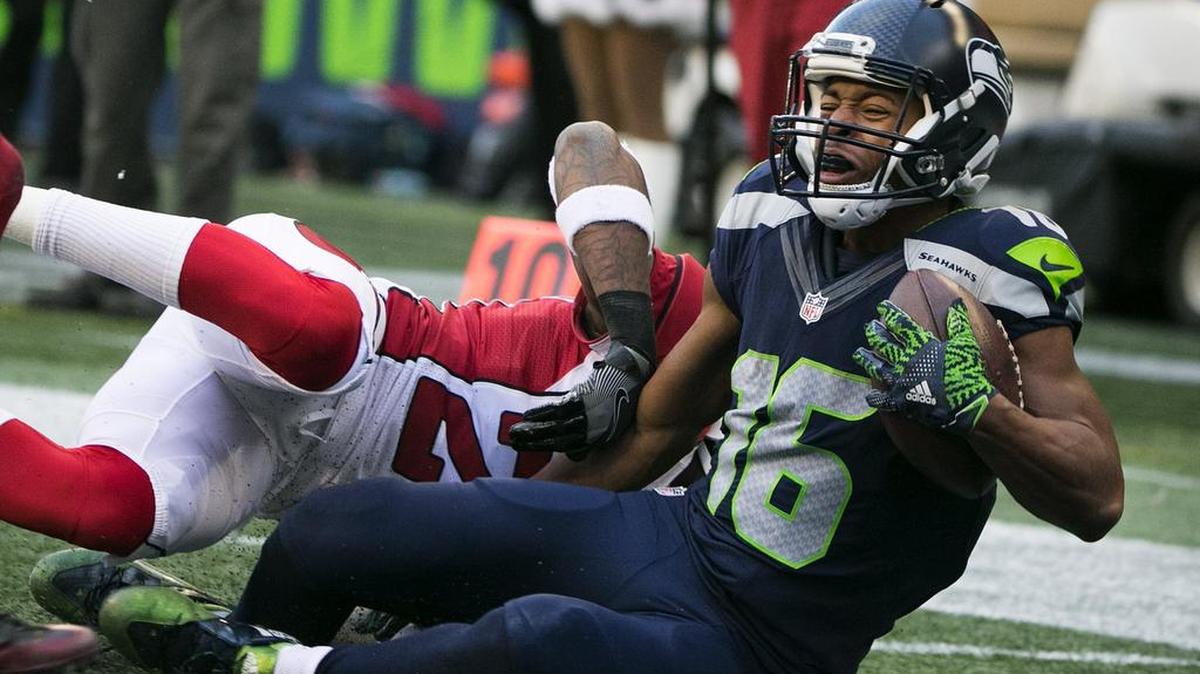 Seahawks receiver Tyler Lockett (16) catches a pass near the end zone against Arizona. Lockett broke two bones in his leg on the play.