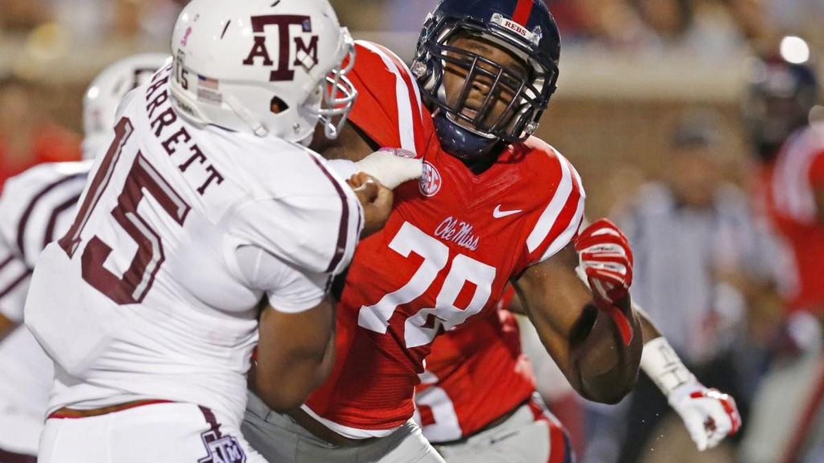 In this Oct. 24, 2015, file photo, Texas A&M defensive lineman Myles Garrett (15) is blocked by Mississippi offensive lineman Laremy Tunsil (78) during the first half of their NCAA college football game in Oxford, Miss. Tunsil is one of the top offensive players available in the NFL Draft, which starts April 28 in Chicago.