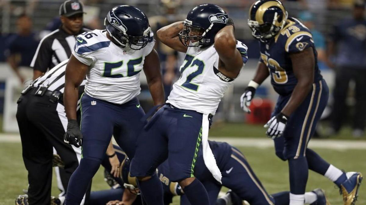 
Seahawks defensive end Michael Bennett, right, celebrates sacking Rams quarterback Nick Foles earlier this season. Bennett has 32.5 career sacks, including two in two games this season.
