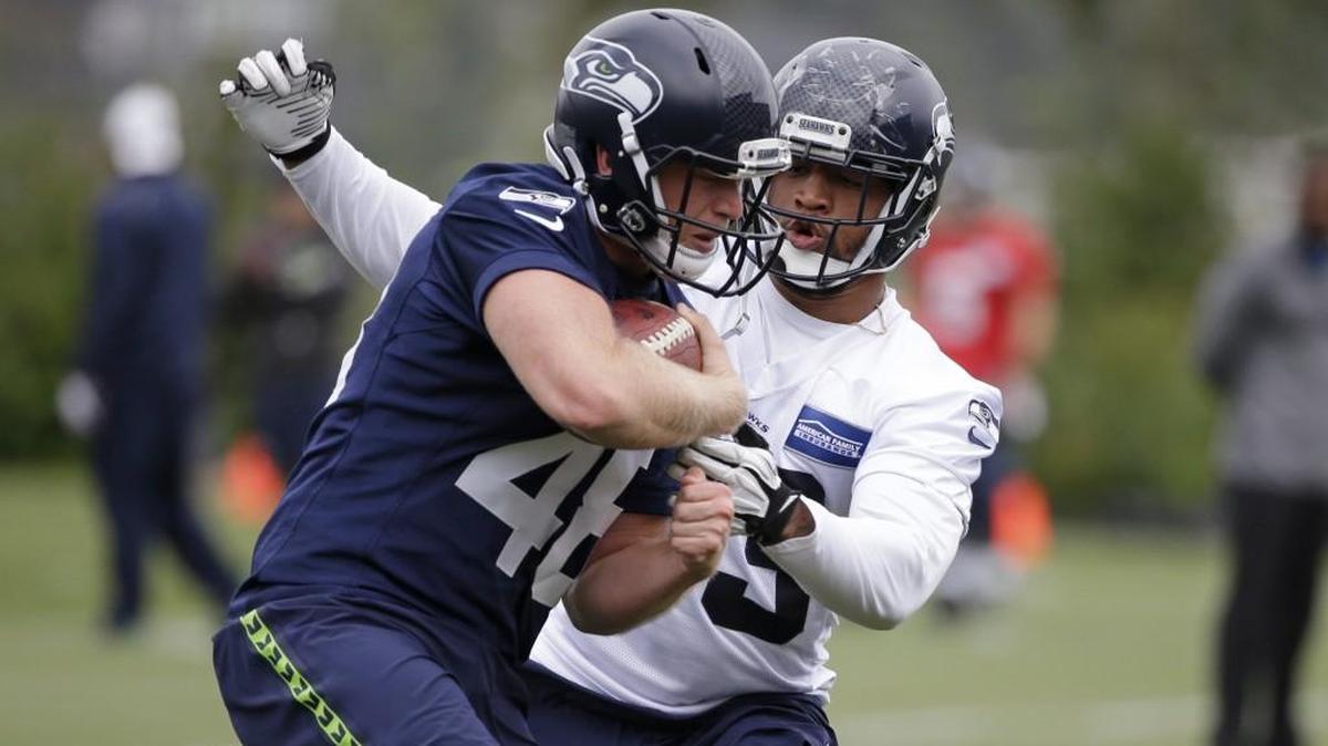 Seattle’s Nolan Frese, left, moves toward Drew Ferris during a drill at the team's NFL football training camp on July 30 in Renton.