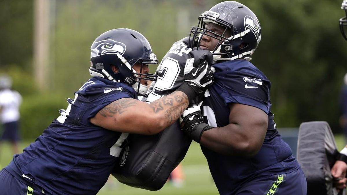 Seahawks rookie offensive lineman Germain Ifedi, right, and Kona Schwenke run through a drill at practice in May. Ifedi, who has been out since Sept. 7 with a high-ankle sprain, will play his first regular season NFL game this Sunday.