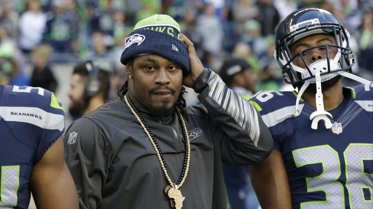 Seattle Seahawks running back Marshawn Lynch, left, stands on the sideline with defensive back Ryan Murphy, right, during the first half of a preseason NFL football game against the Oakland Raiders, Thursday, Sept. 3, 2015, in Seattle.