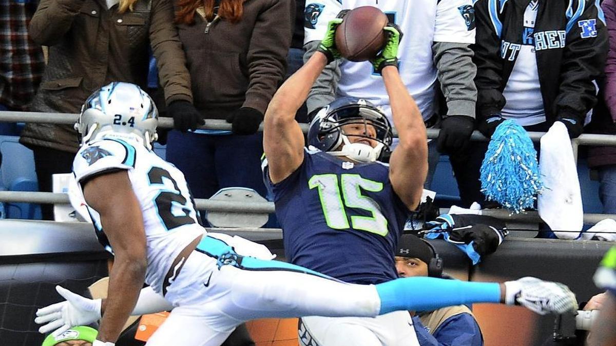 Seattle receiver Jermaine Kearse (15) catches a touchdown as Carolina cornerback Josh Norman defends during the fourth quarter Sunday. Kearse finished with 110 yards on 11 grabs.