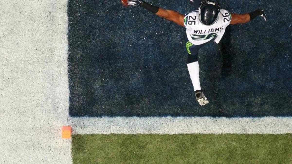 
Seattle Seahawks cornerback Cary Williams scores after sacking St. Louis Rams quarterback Nick Foles, forcing a fumble and returning the fumble eight yards for a touchdown during the second half Sunday. 
