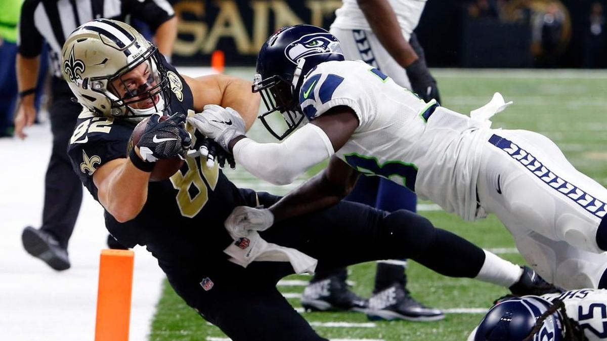 New Orleans’ Coby Fleener, left, is stopped at the goal line by Seattle’s defense, which has played on 162 snaps in the past two games.