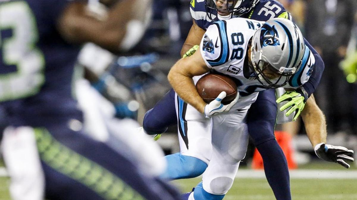 Seahawks player DeShawn Shead (35) tackles Panthers tight end Greg Olsen (88) in the third quarter. The Seattle Seahawks played the Carolina Panthers in a NFL football game at CenturyLink Field in Seattle, Wash., on Sunday, December 4, 2016.