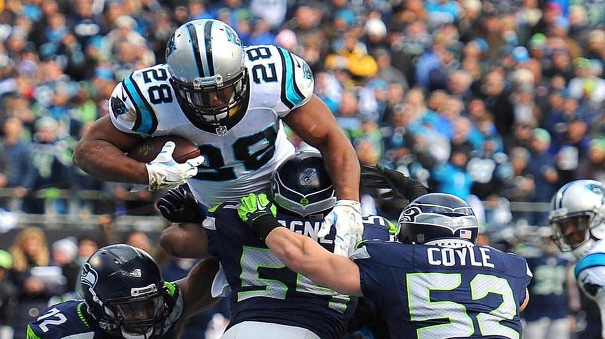 Timberline grad Jonathan Stewart (28) leaps over the Seahawks’ defense to score for the Panthers.