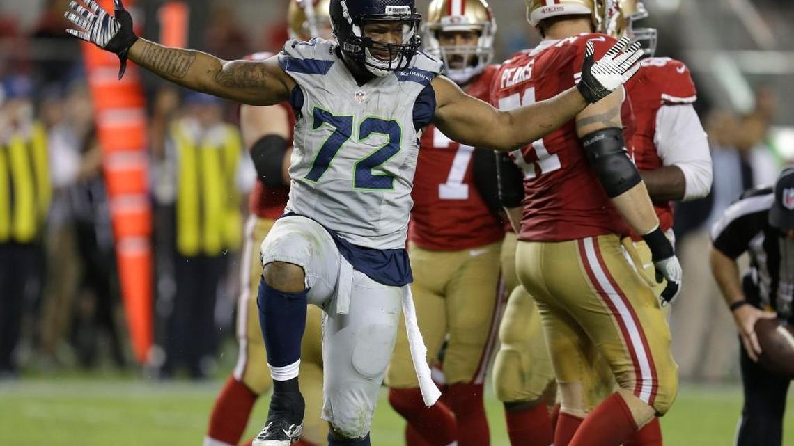 Seattle Seahawks defensive end Michael Bennett (72) reacts after sacking San Francisco 49ers quarterback Colin Kaepernick during the second half of an NFL football game in Santa Clara, Calif., Thursday, Oct. 22, 2015.