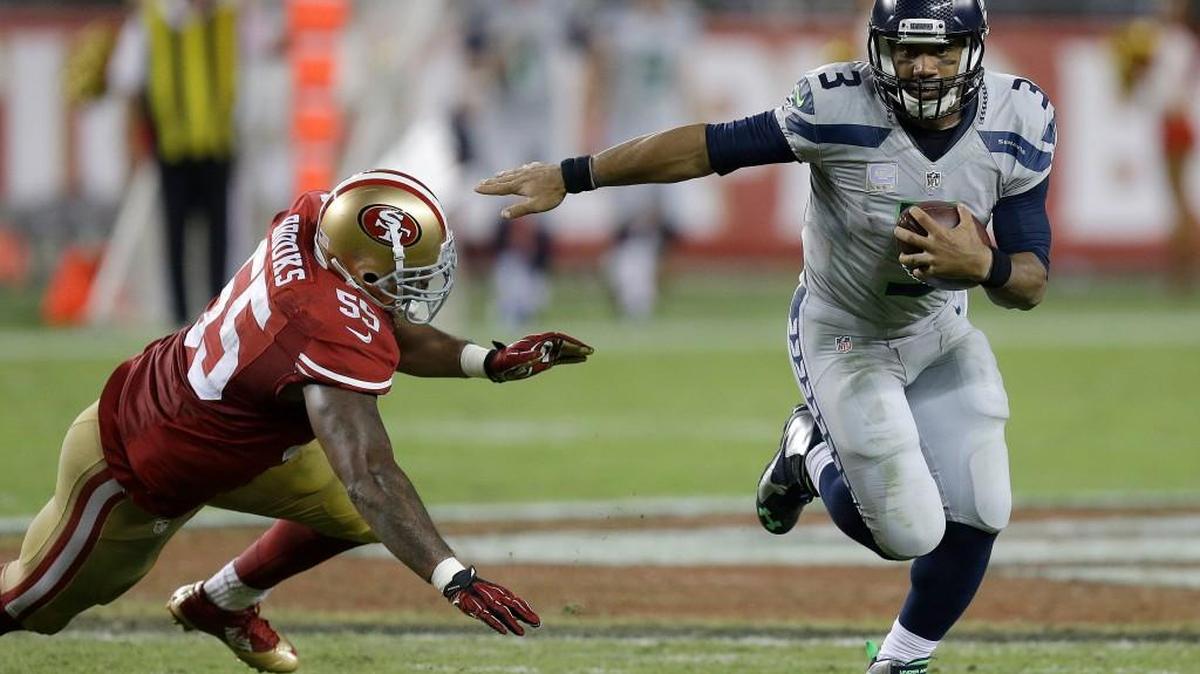 Seattle Seahawks quarterback Russell Wilson (3) runs past San Francisco 49ers linebacker Ahmad Brooks (55) during the second half of an NFL football game in Santa Clara, Calif., Thursday, Oct. 22, 2015.