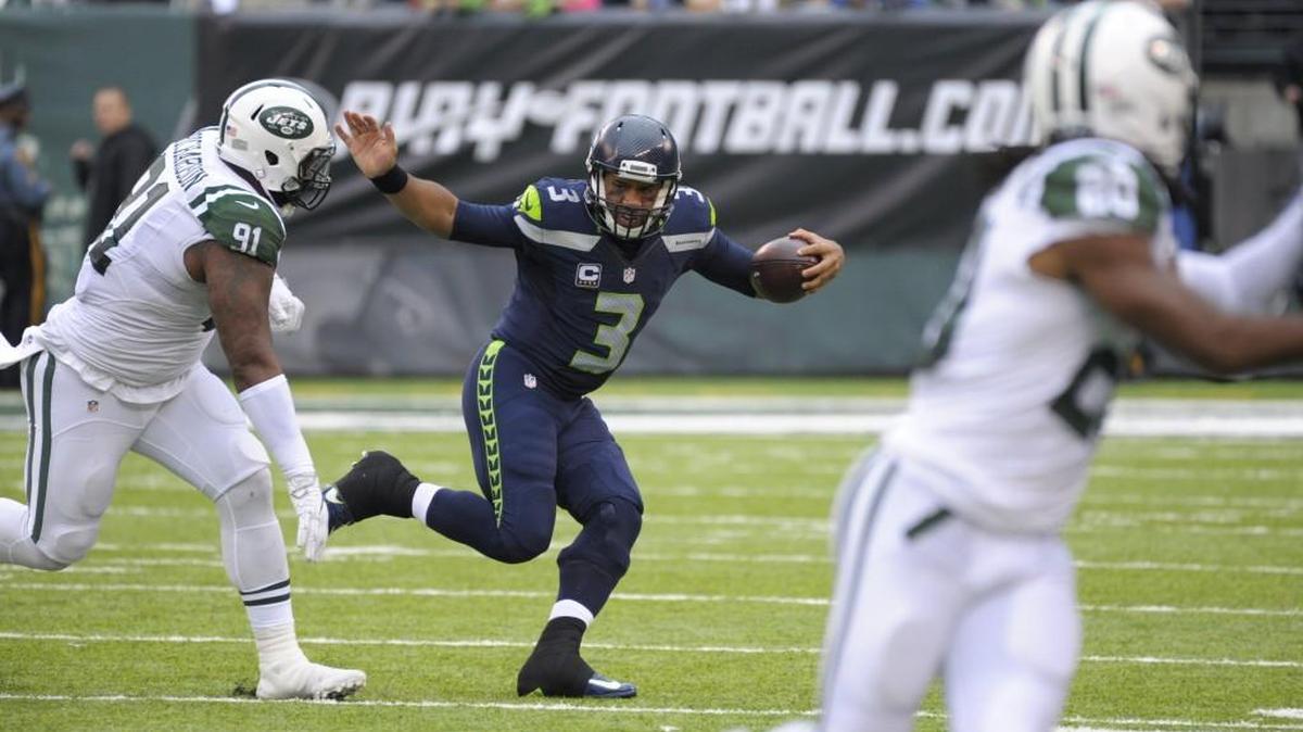 Seattle Seahawks quarterback Russell Wilson (3) runs away from New York Jets' Sheldon Richardson (91) during the second half of an NFL football game Sunday, Oct. 2, 2016, in East Rutherford, N.J.