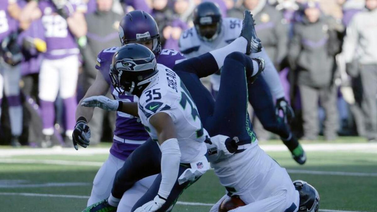 Seattle punter Jon Ryan (9) broke his nose Sunday when he landed on his face after attempting to vault a Minnesota defender. A bad snap forced him to try and run for the first down.