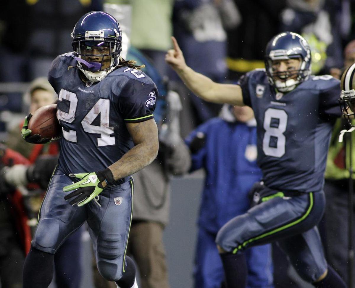 Seattle Seahawks’ Marshawn Lynch (24) breaks away to score a touchdown as quarterback Matt Hasselbeck celebrates in the background during the second half of an NFL NFC wild card playoff football game, Saturday, Jan. 8, 2011, in Seattle against the New Orleans Saints. The Seahawks won 41-36. Lynch finished with 131 yards on 19 carries, the first Seattle back to top 100 yards all season. (AP Photo/Ted S. Warren)