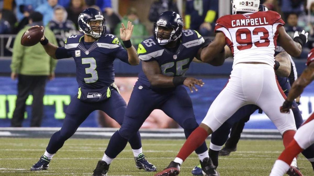 As Seahawks quarterback Russell Wilson drops back to pass Nov. 15 against Arizona, Patrick Lewis, center, holds the line. The center has solidified Seattle’s offensive line since stepping in for Drew Nowak in week six.