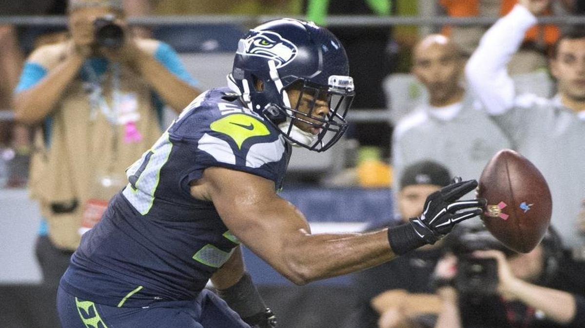 
Seahawks linebacker K.J. Wright reaches for Calvin Johnson’s fumble before the ball went out of the back of the end zone. Some think that an illegal batting penalty should have been called.
