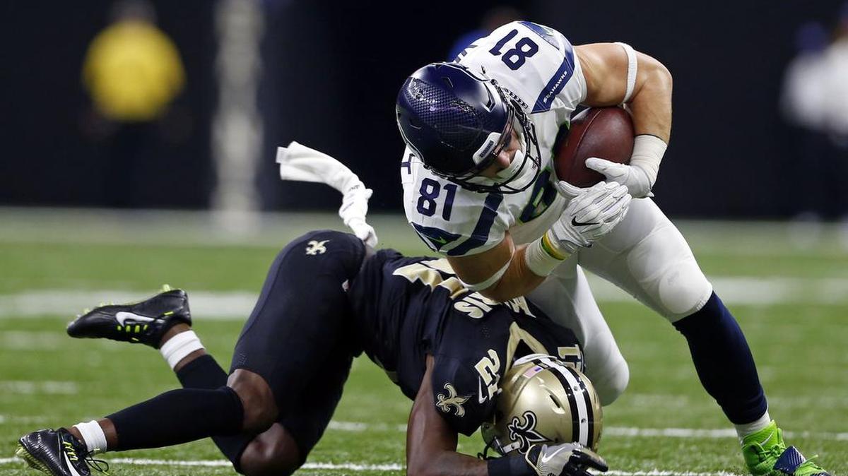 Seahawks rookie tight end Nick Vannett (81) is stopped by New Orleans Saints cornerback De’Vante Harris (21) in the second half against New Orleans.