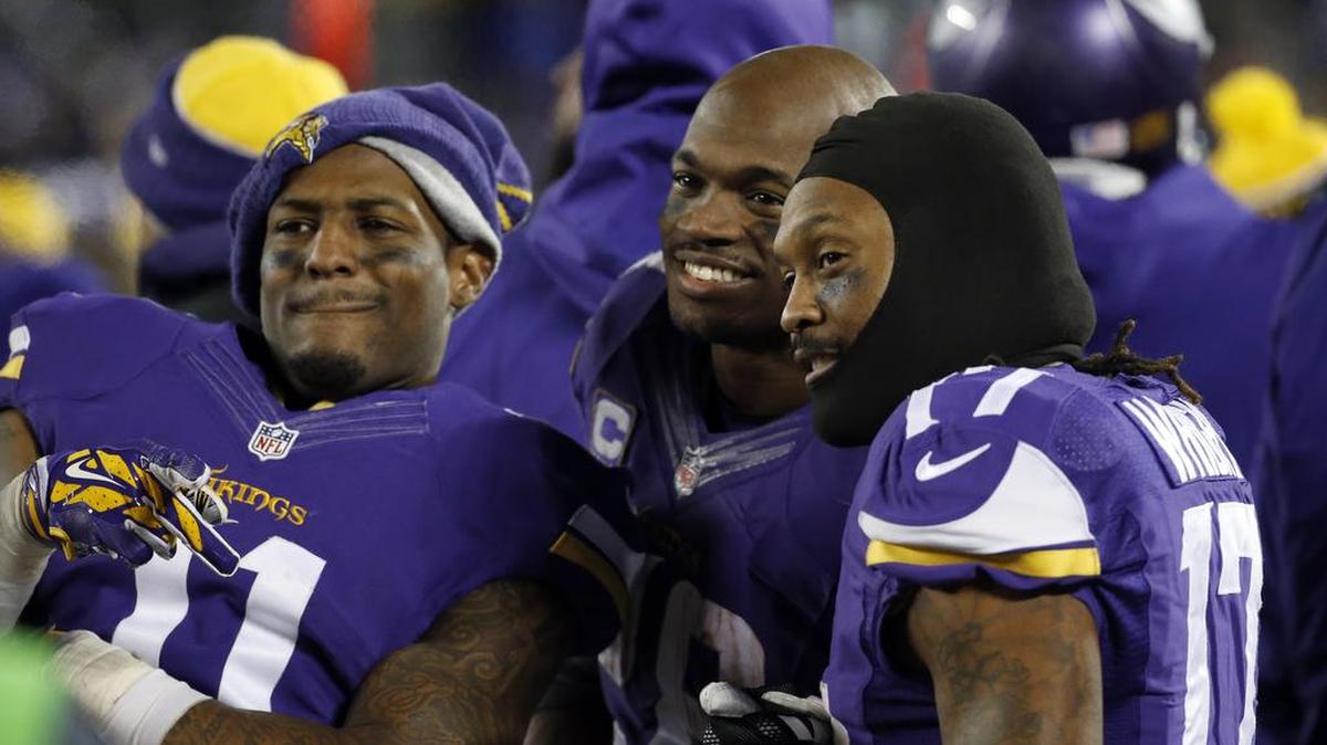 FILE - In this Dec. 27, 2015, file photo, Minnesota Vikings wide receiver Mike Wallace (11), running back Adrian Peterson (28) and wide receiver Jarius Wright (17) react on the sideline during the second half of an NFL football game against the New York Giants in Minneapolis. The Vikings hosted the Giants at the ninth-coldest game in their history. (AP Photo/Ann Heisenfelt, File)