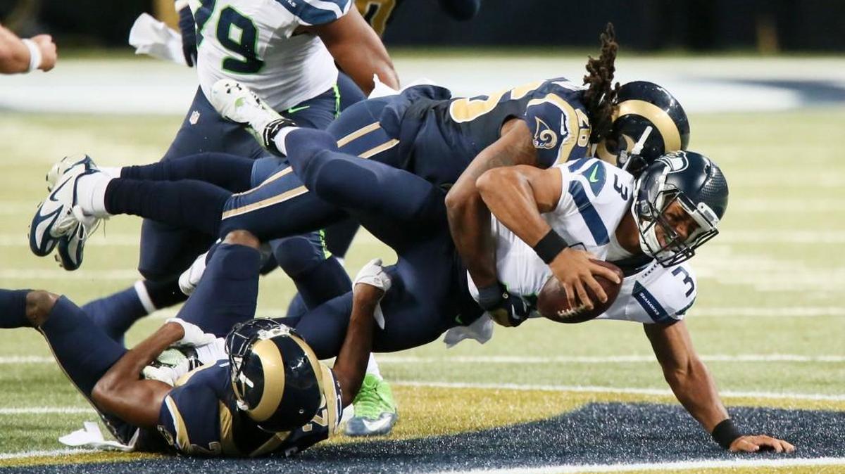 
Seattle Seahawks quarterback Russell Wilson (3) is sacked for a 10-yard loss on third down by St. Louis Rams defensive backs Lamarcus Joyner, lower left, and Mark Barron in the second quarter Sunday. Wilson was sacked six times. 

