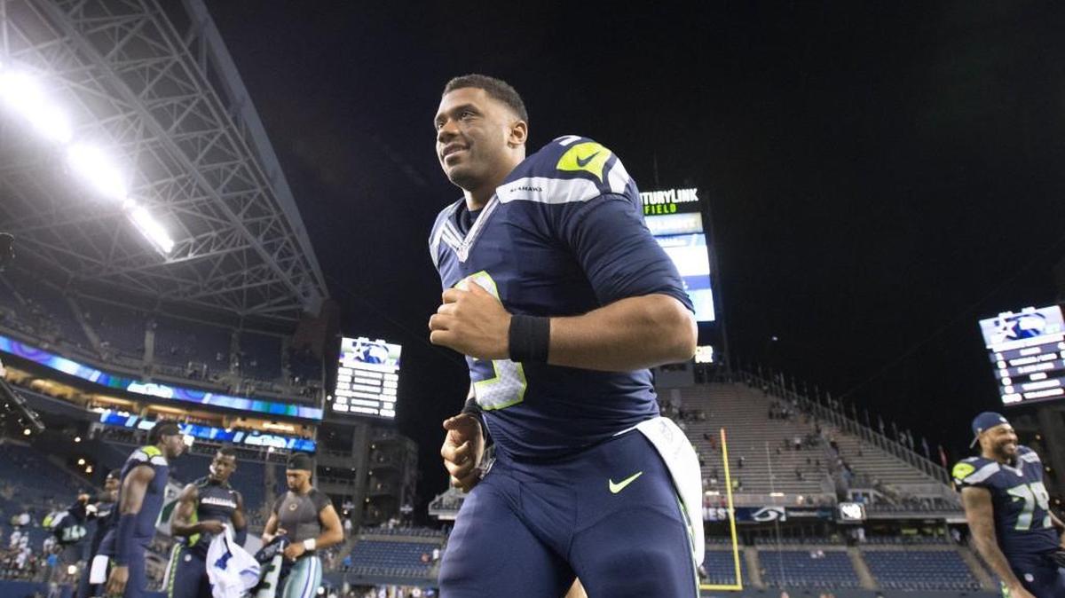 Seahawks quarterback Russell Wilson runs off the field following the Seahawks preseason NFL football win over the Dallas Cowboys Aug. 25.