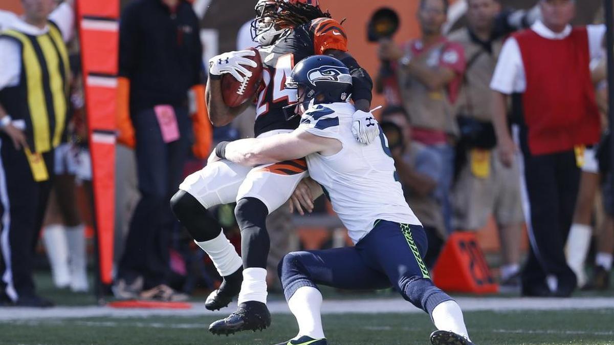 
Cincinnati Bengals cornerback Adam Jones (24) is tackled by Seattle Seahawks punter Jon Ryan on a second-half punt return. 
