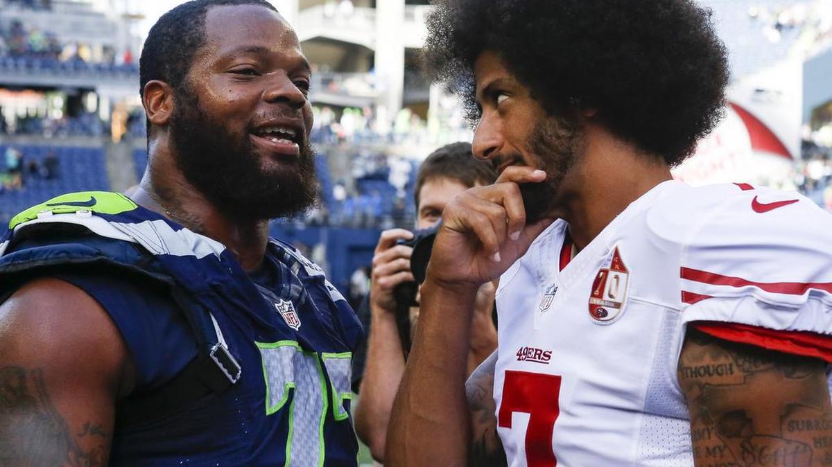 Two men not afraid to speak their mind as Seahawks defensive end Michael Bennett, left, talks with 49ers quarterback Colin Kaepernick after their game at CenturyLink Field two weeks ago.