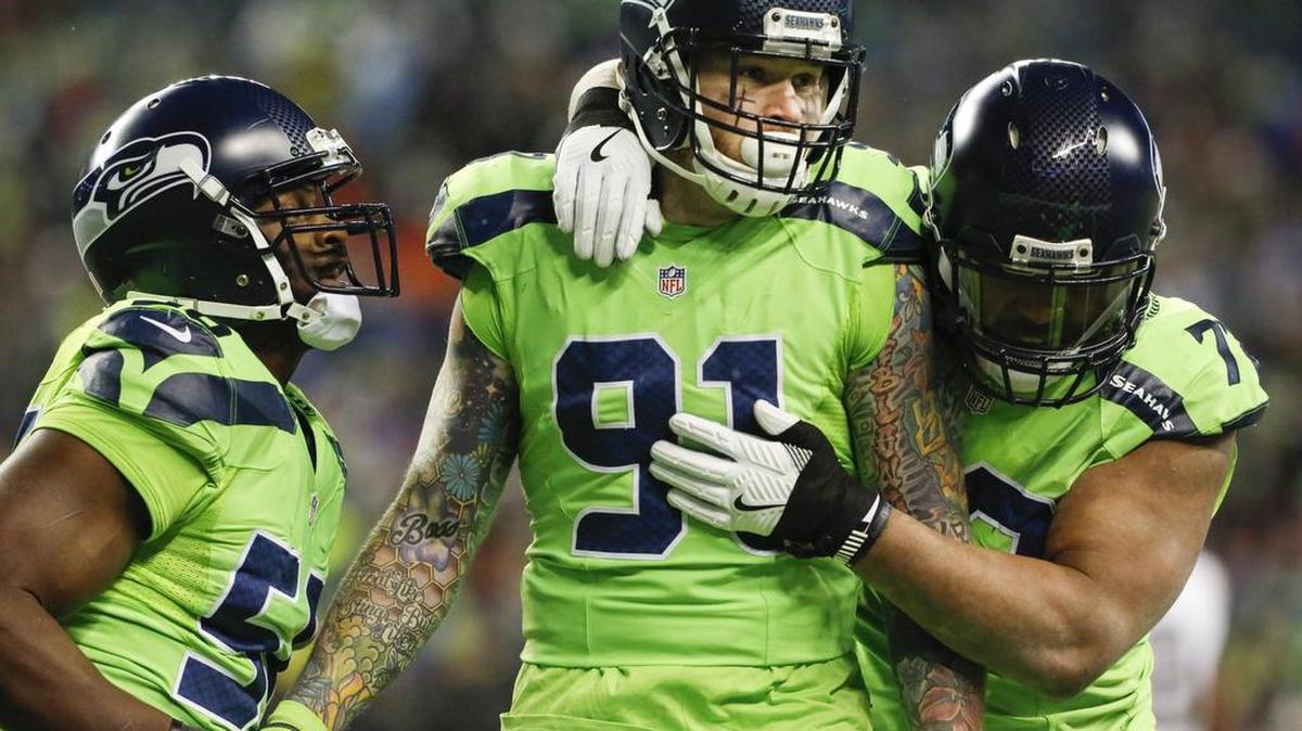 Seahawks defensive lineman Michael Bennett, right, linebacker K.J. Wright, left, and defensive lineman Cassius Marsh, center, celebrate a sack of Rams quarterback Jared Goff in the third quarter. Despite the strange season the Seahawks have been playing through — particularly this past week — the team insists all the players are pulling for each other.