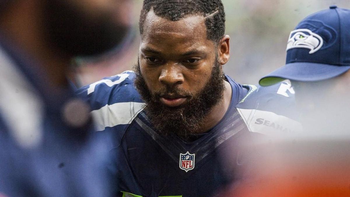 Seahawks defensive lineman Michael Bennett is led back to the bench after getting hurt on a chop block. Bennett said he will be able to play this Sunday against Arizona.