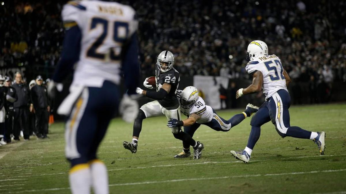 Oakland Raiders' Charles Woodson (24) is tackled by San Diego Chargers inside linebacker Manti Te'o (50) during overtime on Dec. 24.