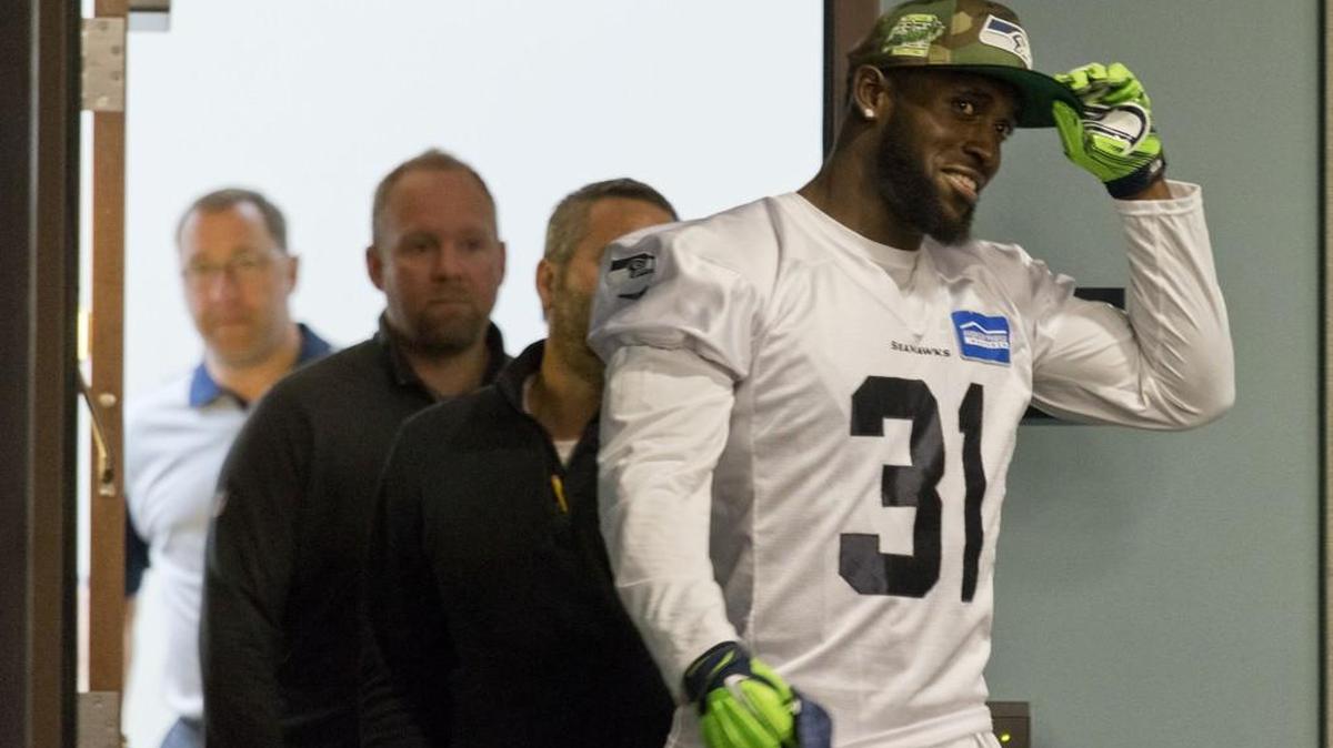 
Seattle Seahawks star strong safety Kam Chancellor tips his cap as he meets with the media after ending his holdout Wednesday.
