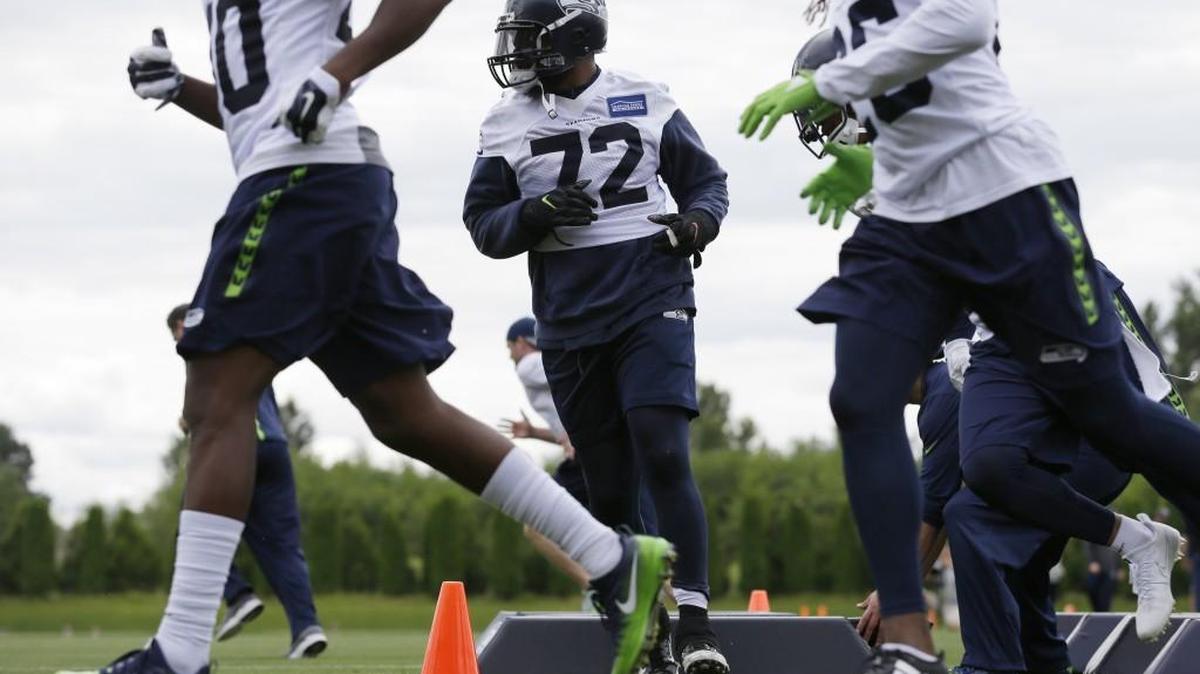Seattle Seahawks defensive end Michael Bennett (72) runs an agility drill in Renton.