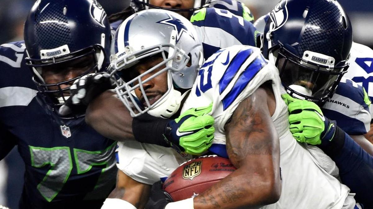 Seattle Seahawks' Ahtyba Rubin (77) and Frank Clark, right, combine to stop Dallas Cowboys' Darren McFadden (20) on a running play in the second half of an NFL football game Sunday, Nov. 1, 2015, in Arlington, Texas.