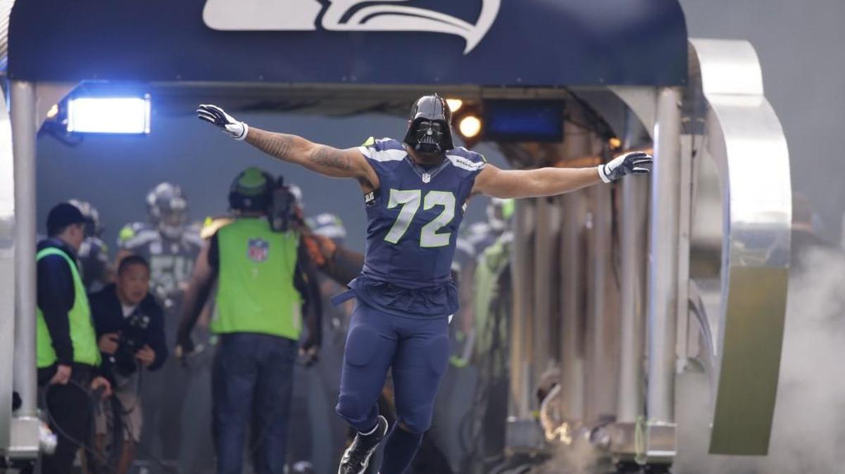 Seahawks defensive end Michael Bennett wears a Darth Vader mask as he runs onto the field before his game against the Browns on Sunday. On Wednesday, Bennett endorsed Bernie Sanders for president in a rare public political display by a professional athlete.