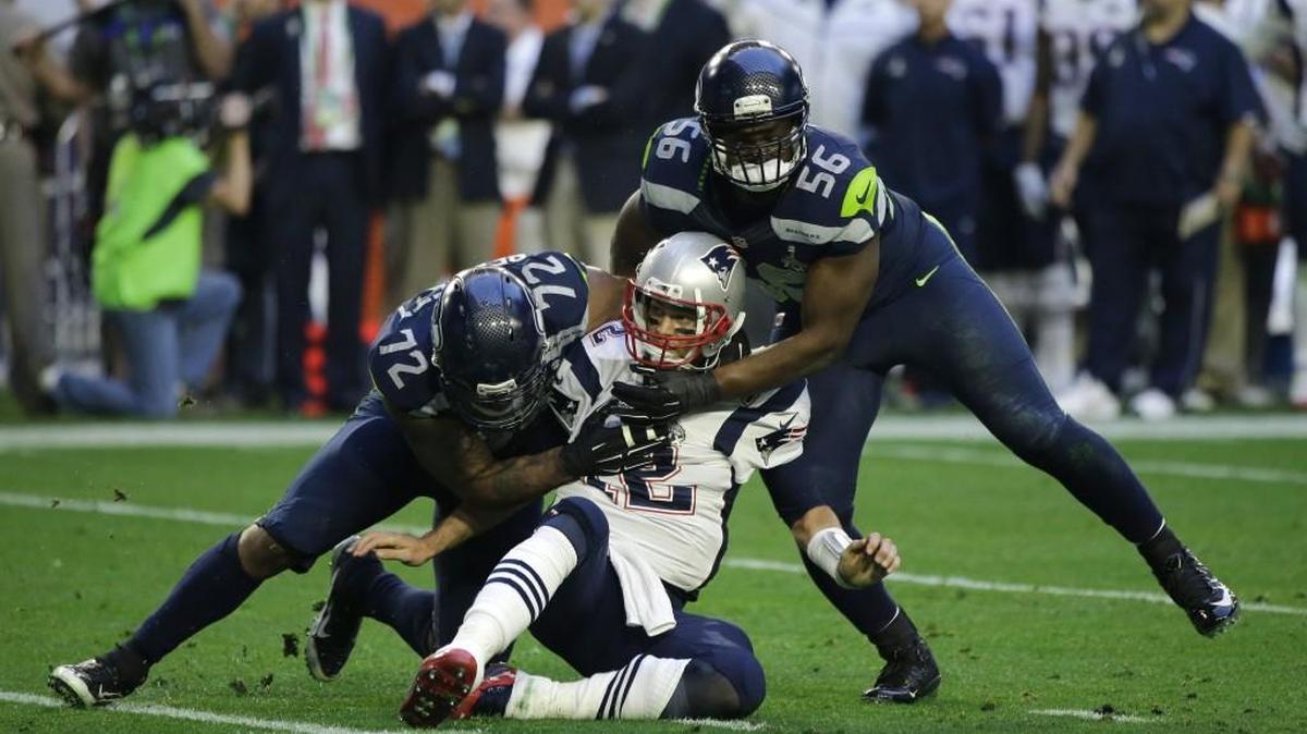 
New England Patriots quarterback Tom Brady, center, gets hit by Michael Bennett, left, and Cliff Avril during the first half of Super Bowl XLIX in February. Avril’s later injury and his exit from the game hurt the Seahawks down the stretch.

