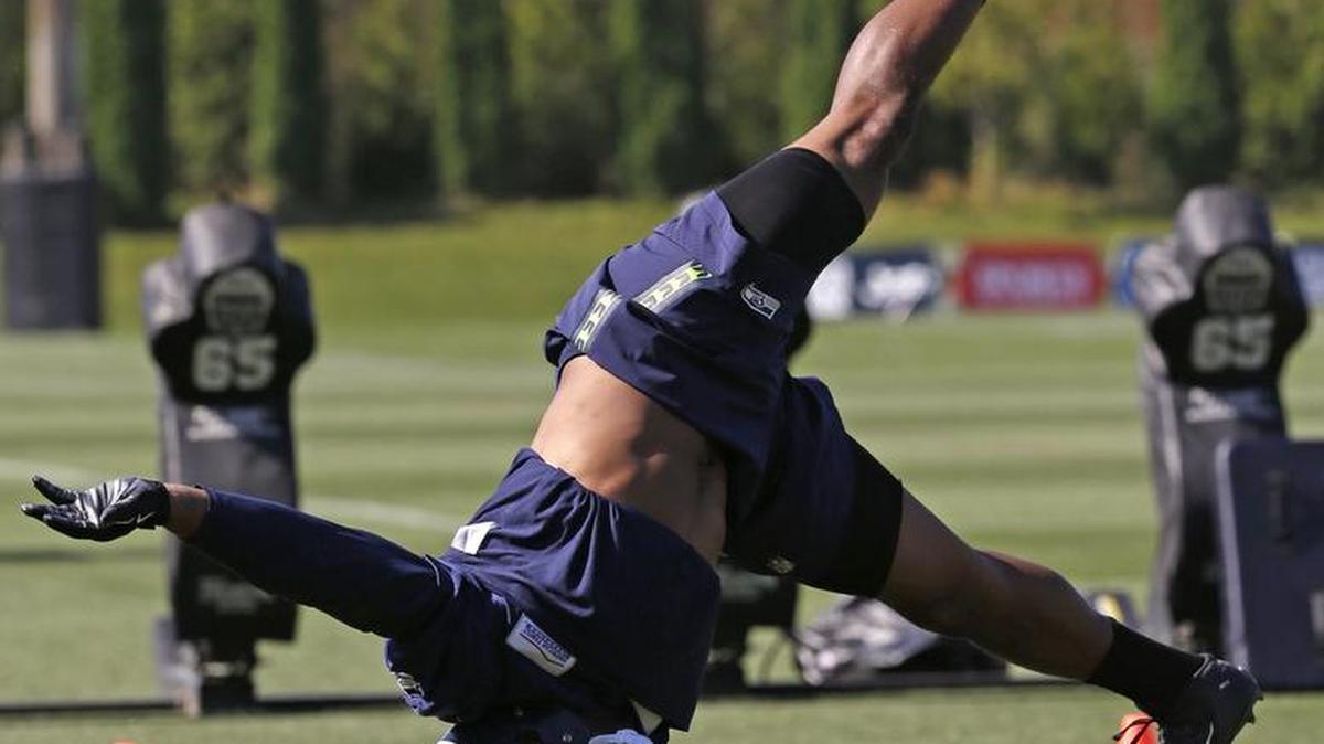 
Seahawks linebacker Bobby Wagner pushes off of one arms as he completes a handstand between drills during the final day of training camp Wednesday at team headquarters in Renton.

