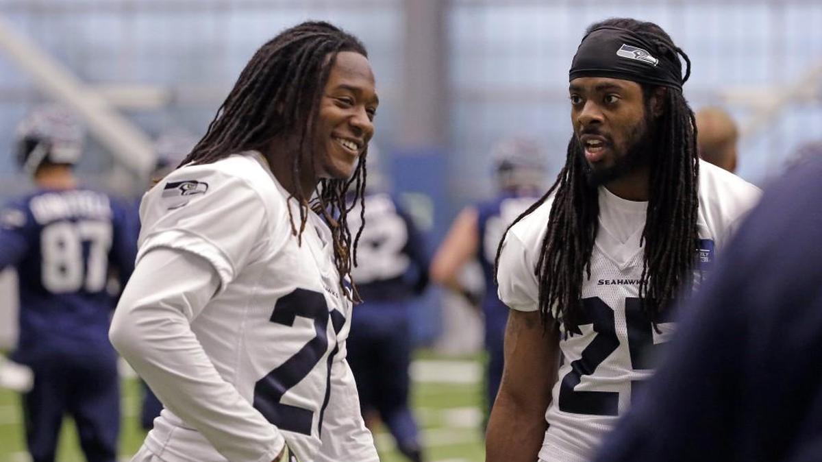 Richard Sherman (right) jokes with rookie and fellow cornerback Shaquill Griffin during the Seahawks’ final practice of the offseason Thursday in Renton. The minicamp finale had a definite last-day-of-school feel to it.