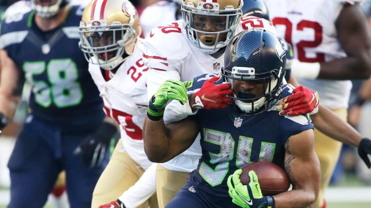 Seattle Seahawks running back Thomas Rawls (34) is tackled by San Francisco 49ers cornerback Kenneth Acker (20) as he rushes in the first half of an NFL football game, Sunday, Nov. 22, 2015, in Seattle.