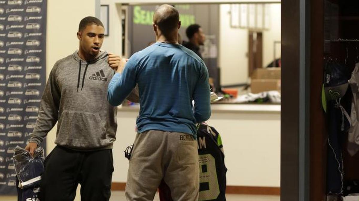 Seahawks wide receiver and Pro Bowl alternate Doug Baldwin, back to camera riding a hoverboard on the team’s end-of-season cleanout day, says goodbye to defensive back George Farmer in the locker room Monday. Baldwin could end up playing in the all-star game. Farmer signed a futures contract with Seattle this week.