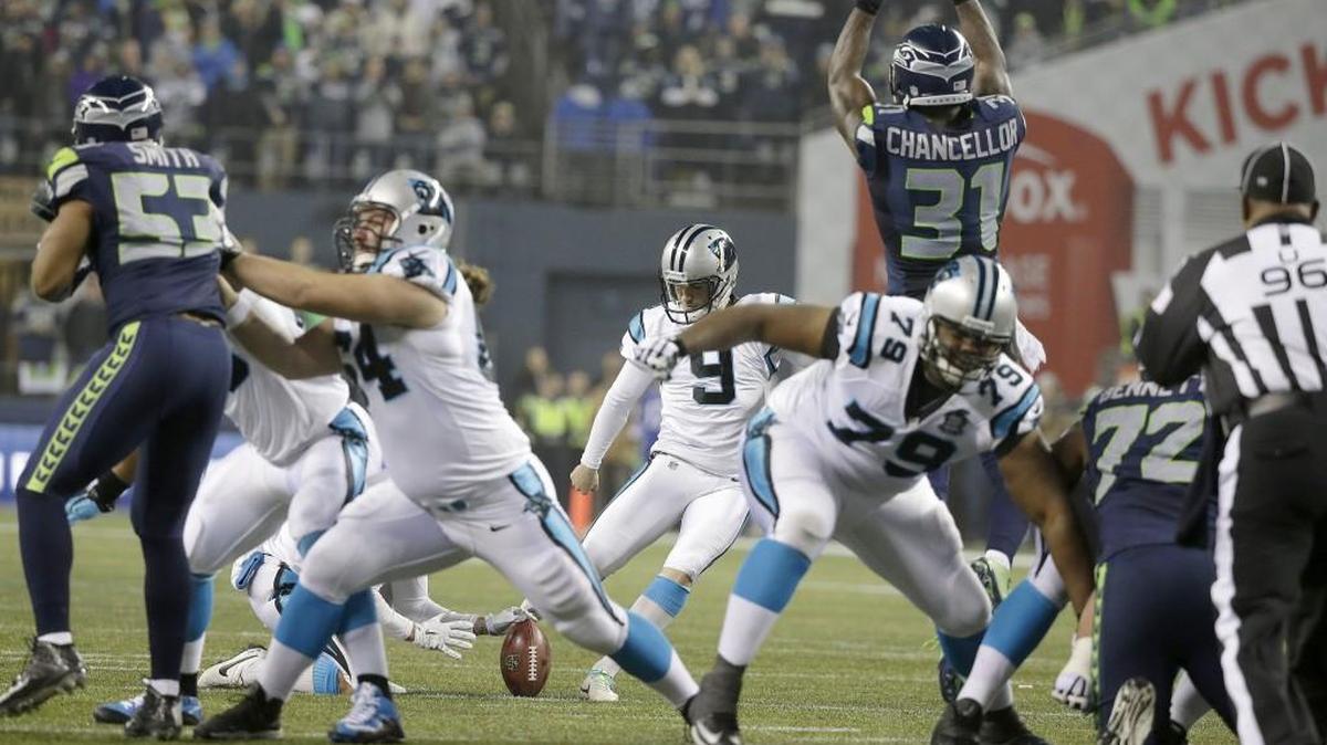 Seattle Seahawks strong safety Kam Chancellor leaps to try and block a field goal attempt by Carolina Panthers kicker Graham Gano during the first half of an NFL divisional playoff football game in Seattle, Saturday, Jan. 10, 2015. Gano missed the attempt but a Seahawks penalty negated the play.