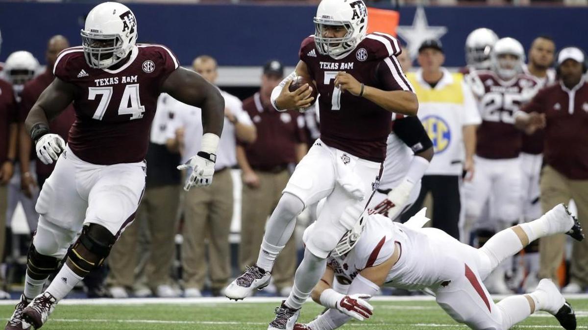 Texas A&M offensive tackle Germain Ifedi (74), hear clearing room for his quarterback in a 2014 game, says he’s “blessed” to be in a “perfect fit” with the Seahawks -- even as national views panned Seattle’s top pick in Thursday’s NFL draft.
