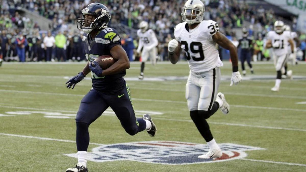 
Seattle Seahawks wide receiver Tyler Lockett runs for a touchdown after catching a pass from quarterback Russell Wilson as Oakland Raiders cornerback Keith McGill (39) pursues, in the first half of a preseason NFL football game, Thursday, Sept. 3, 2015, in Seattle.

