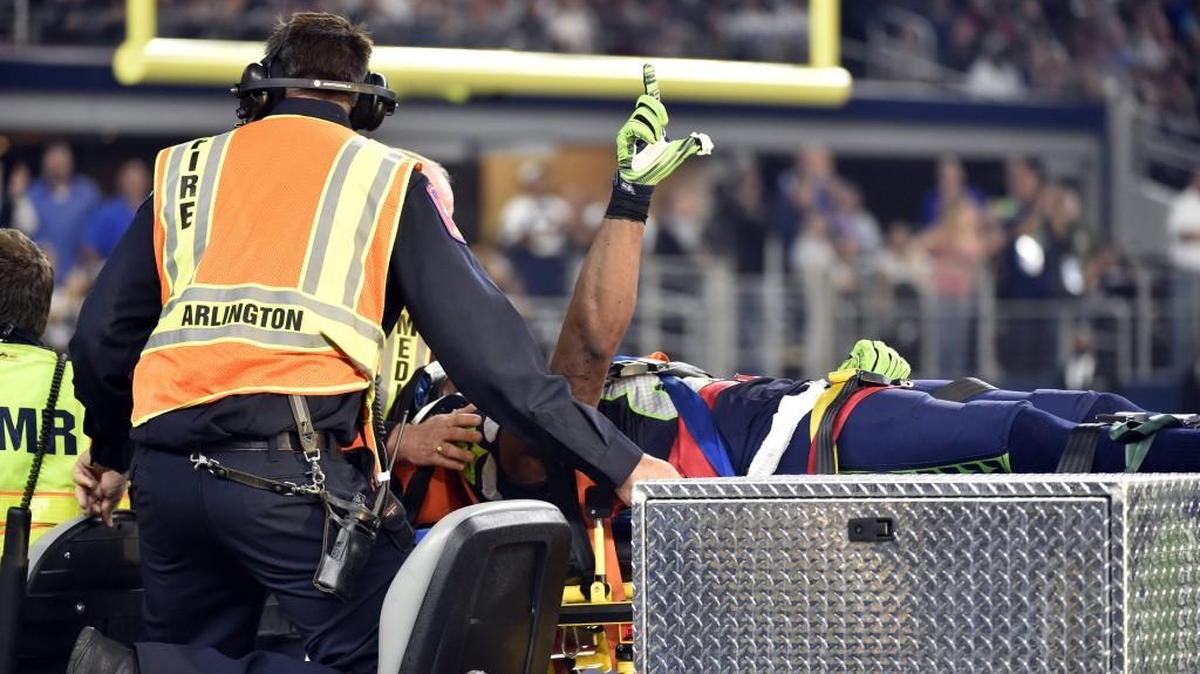 Seattle Seahawks’ Ricardo Lockette signals to cheering fans as he is carted off the field during Sunday’s game against the Dallas Cowboys. Lockette was to have surgery in Dallas on Monday to repair a ligament in his neck and is out for the season.