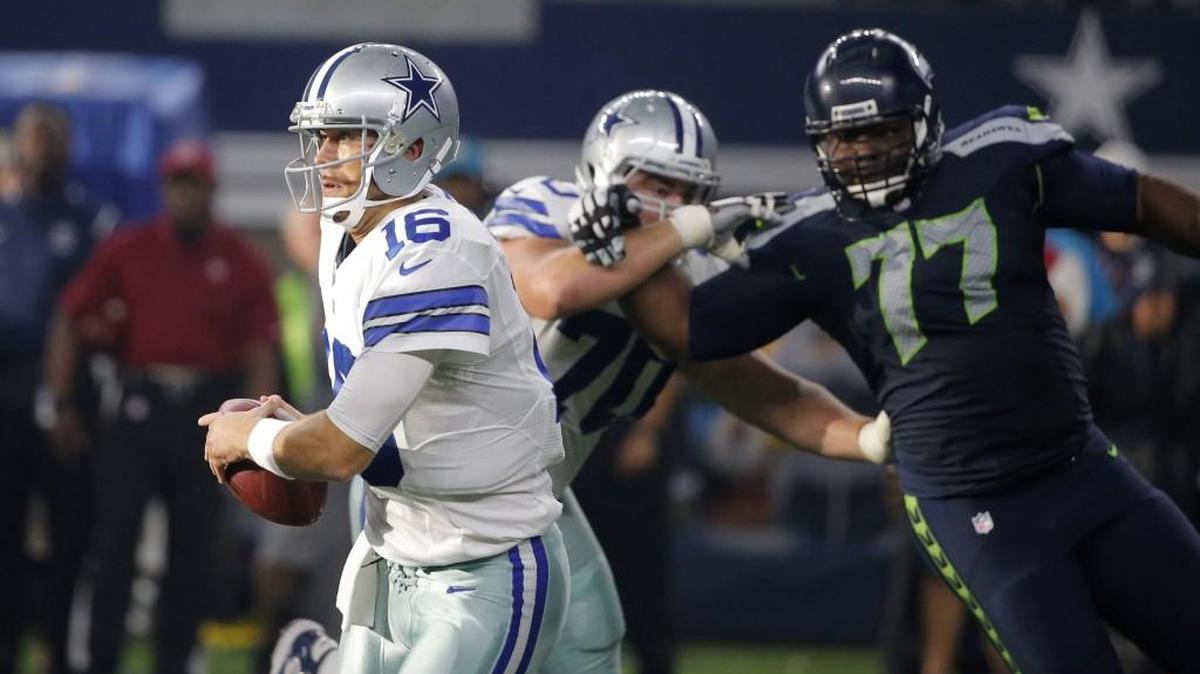 Dallas Cowboys' Matt Cassel (16) runs out of the pocket under pressure from Seattle Seahawks' Ahtyba Rubin (77) in the first half of an NFL football game Sunday, Nov. 1, 2015, in Arlington, Texas.